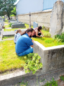 After a trip to town to purchase the necessary tools, the Angove family begins tending the grave.