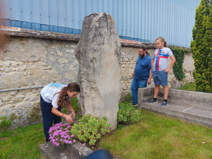 Completing their work of tending the gravesite with conscious attention, the Angove family provides the final watering.